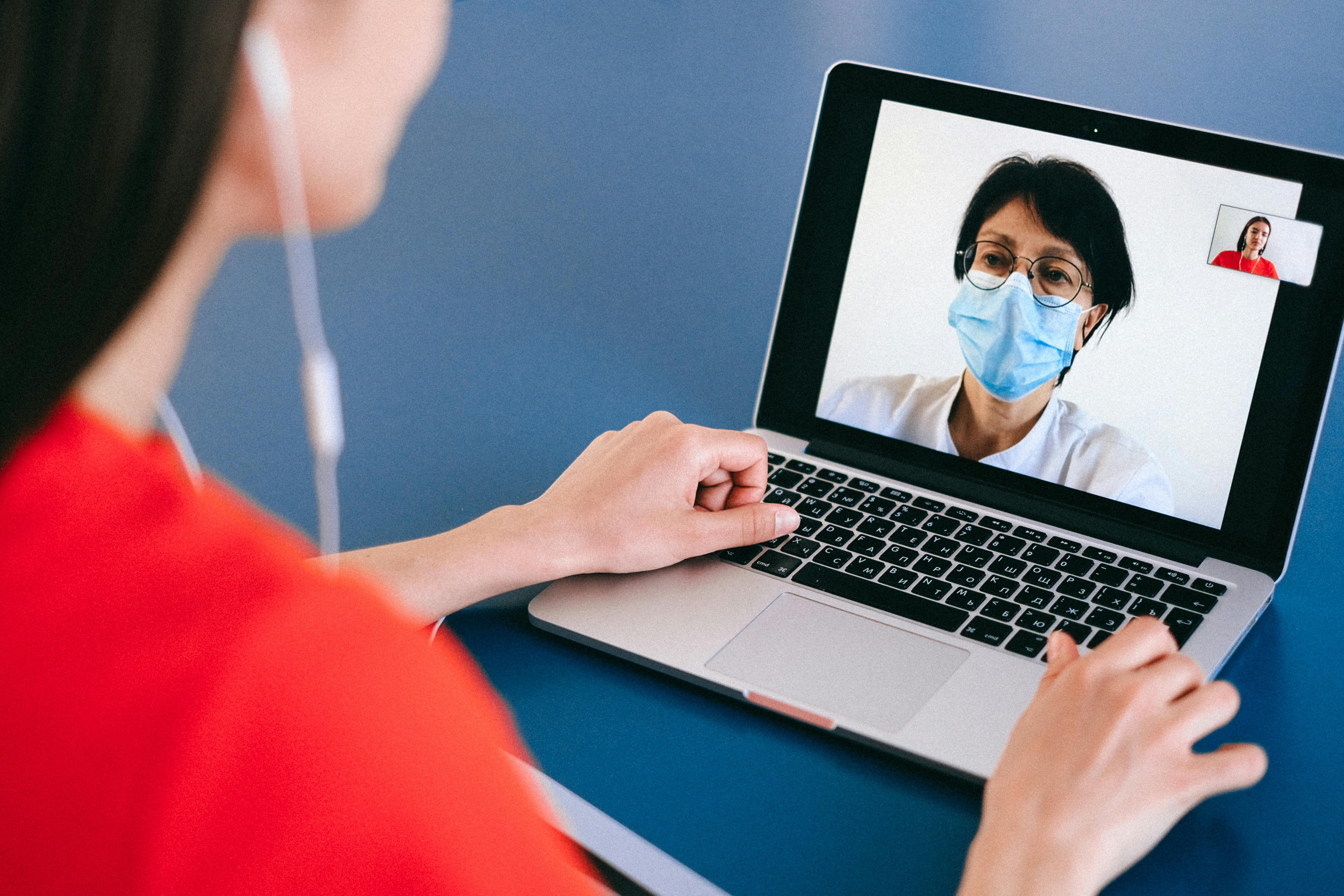 Female talking to doctor on computer screen