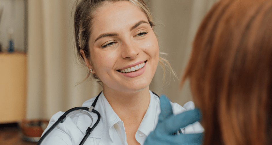 Doctor smiling while examining patient's face